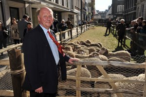 Jim Paice, UK farming minister, watches sheep graze in Saville Row